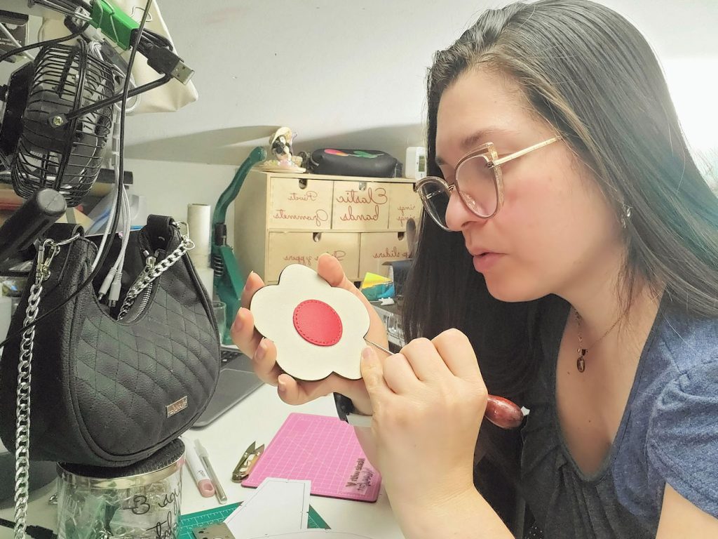 A crafter handcrafting a handbag
